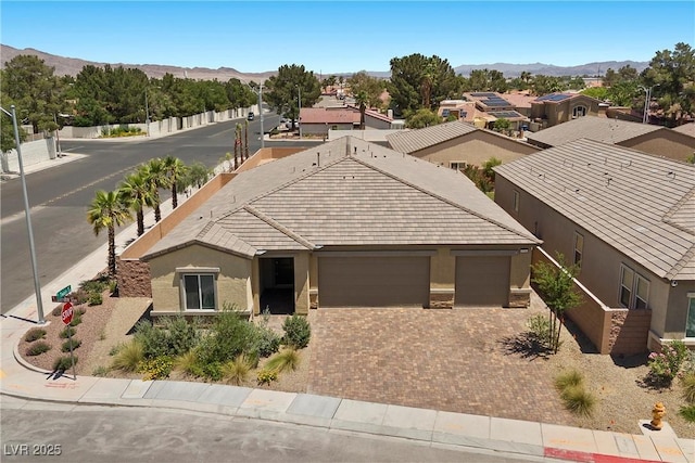 3706 Etendre Ct, Las Vegas, NV 89121 - view of front facade with stucco siding, a garage, driveway, and a mountain view