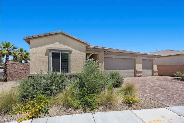 3706 Etendre Ct, Las Vegas, NV 89121 - view of front facade with stucco siding, an attached garage, and decorative driveway