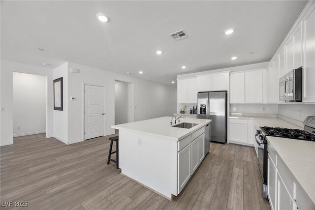 3706 Etendre Ct, Las Vegas, NV 89121 - kitchen featuring appliances with stainless steel finishes, a sink, light wood finished floors, light countertops, and recessed lighting