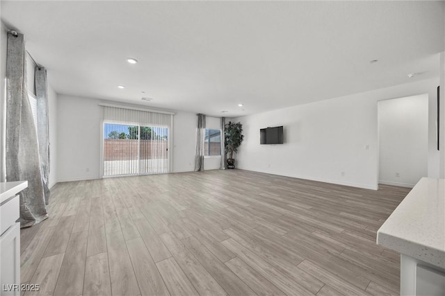 3706 Etendre Ct, Las Vegas, NV 89121 - unfurnished living room with light wood finished floors, recessed lighting, and baseboards