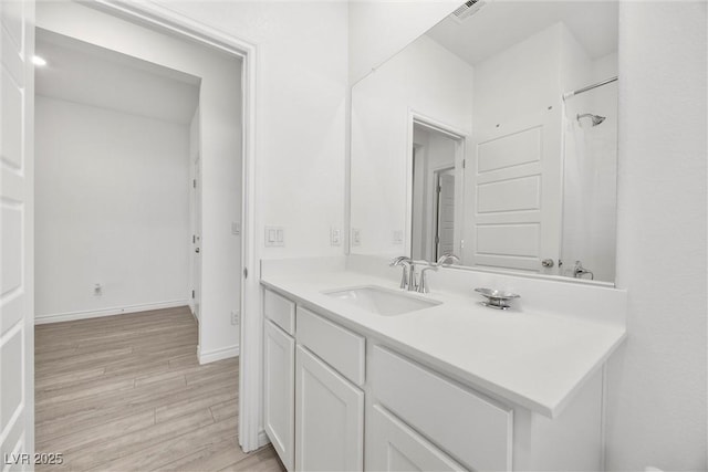 3706 Etendre Ct, Las Vegas, NV 89121 - bathroom with wood finished floors, vanity, baseboards, and a shower
