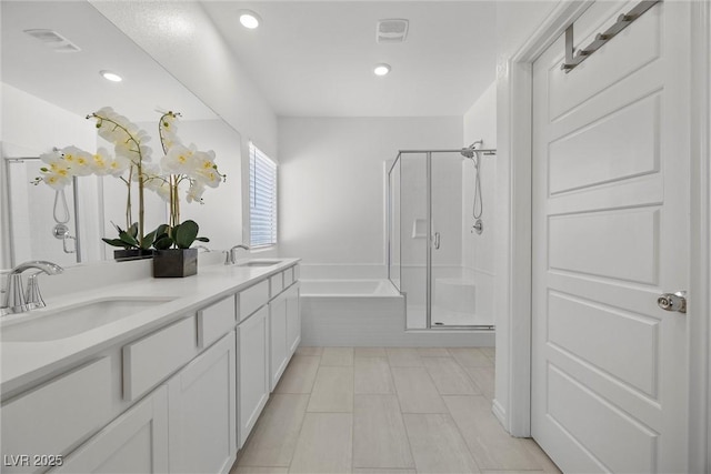 3706 Etendre Ct, Las Vegas, NV 89121 - bathroom with a shower stall, a garden tub, double vanity, tile patterned floors, and recessed lighting