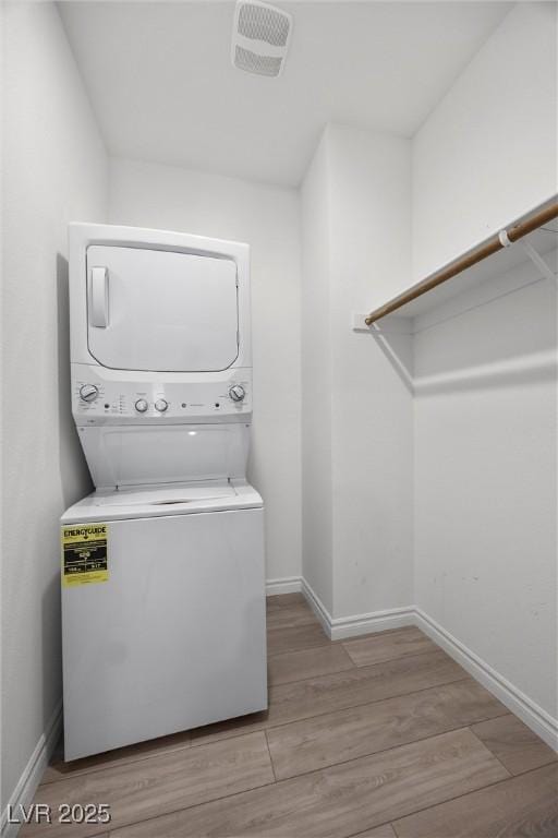 3706 Etendre Ct, Las Vegas, NV 89121 - washroom with stacked washing machine and dryer, wood finished floors, and baseboards