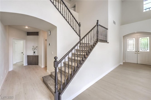 3065 Blue Monaco St, Las Vegas, NV 89117 - foyer entrance with arched walkways, wood finished floors, a towering ceiling, and stairs