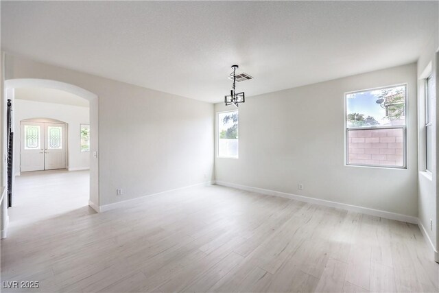 3065 Blue Monaco St, Las Vegas, NV 89117 - unfurnished room featuring arched walkways and light wood-style floors