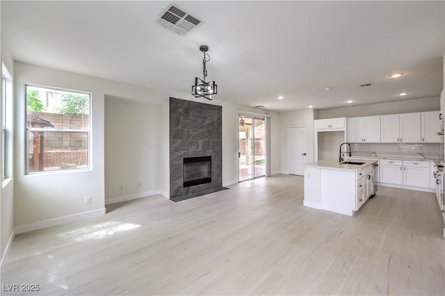 3065 Blue Monaco St, Las Vegas, NV 89117 - kitchen with open floor plan, recessed lighting, light countertops, light wood-style floors, and pendant lighting
