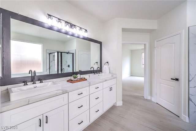 3065 Blue Monaco St, Las Vegas, NV 89117 - full bath with a shower stall, double vanity, and wood finished floors