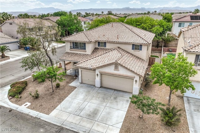 3065 Blue Monaco St, Las Vegas, NV 89117 - view of front of home featuring stucco siding, a tiled roof, concrete driveway, an attached garage, and a mountain view