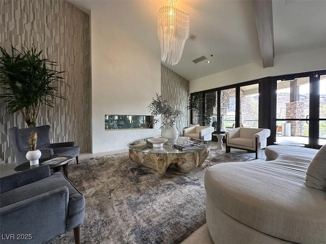 living area featuring healthy amount of natural light, a chandelier, and beam ceiling