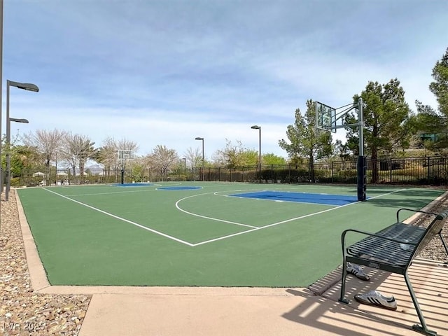 view of basketball court with community basketball court and fence