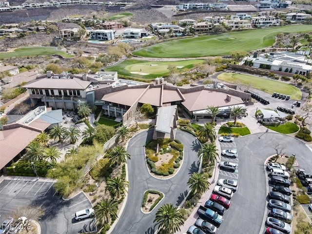 aerial view of property and surrounding area with a golf course
