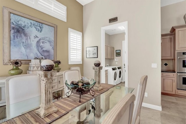 dining area featuring washer and clothes dryer and baseboards