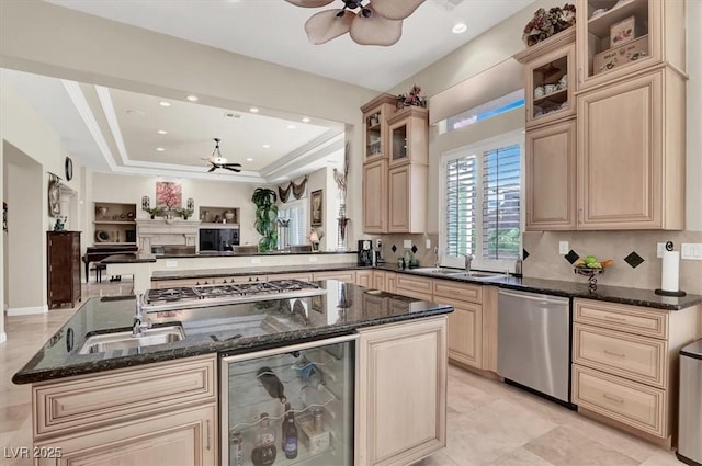 kitchen featuring appliances with stainless steel finishes, wine cooler, a ceiling fan, a sink, and open floor plan