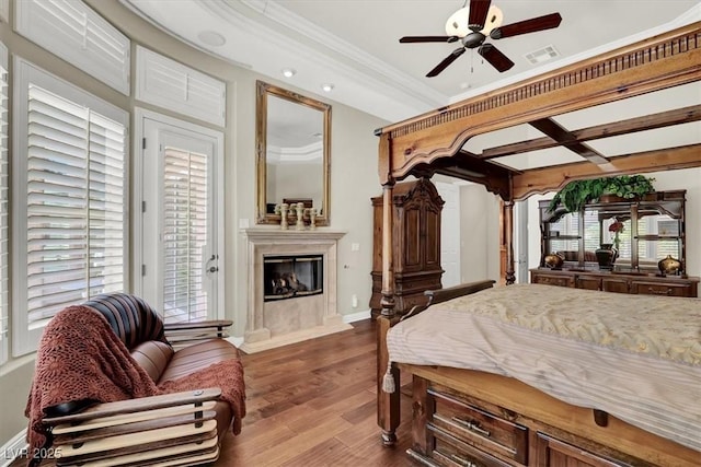 bedroom with a high end fireplace, wood finished floors, crown molding, access to exterior, and baseboards
