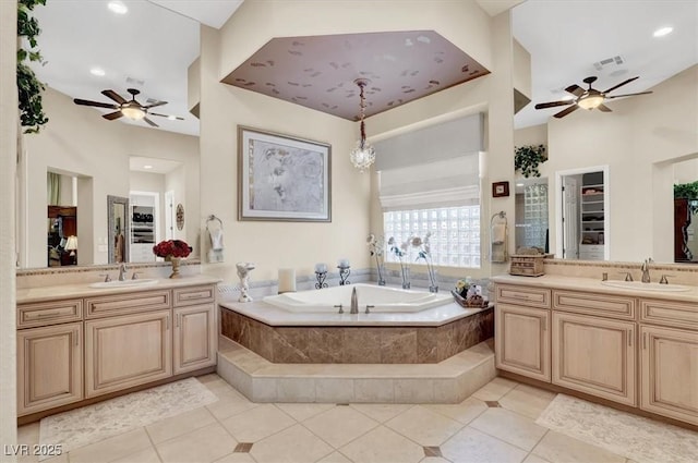 full bathroom with a ceiling fan, two vanities, a garden tub, tile patterned floors, and recessed lighting