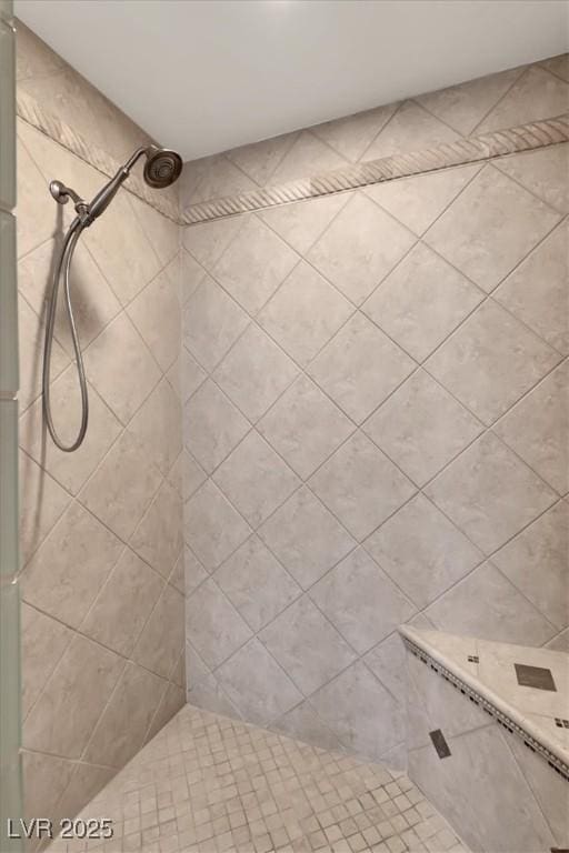full bath featuring tiled shower
