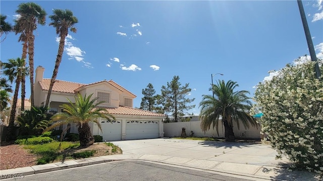 1211 Silver Knoll Ave, Las Vegas, NV 89123 - view of front of home featuring driveway, a tile roof, fence, stucco siding, and a garage