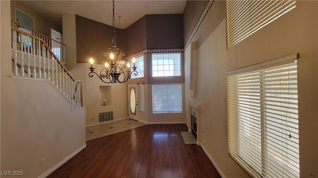 1211 Silver Knoll Ave, Las Vegas, NV 89123 - foyer entrance with a towering ceiling, a chandelier, wood finished floors, stairs, and baseboards
