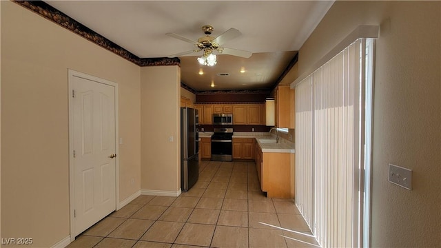 1211 Silver Knoll Ave, Las Vegas, NV 89123 - kitchen featuring appliances with stainless steel finishes, light countertops, a sink, ceiling fan, and light tile patterned floors