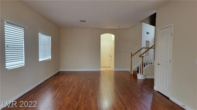 1211 Silver Knoll Ave, Las Vegas, NV 89123 - unfurnished room featuring arched walkways, wood finished floors, and stairs