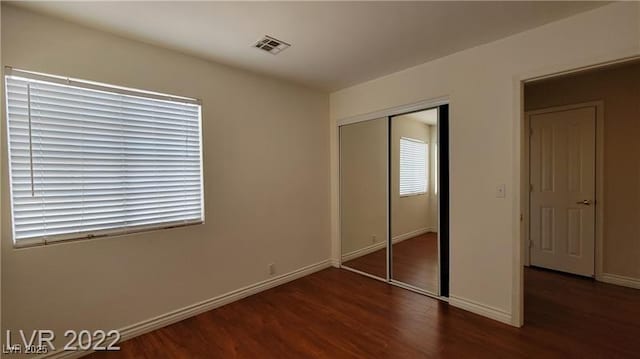 1211 Silver Knoll Ave, Las Vegas, NV 89123 - unfurnished bedroom with wood finished floors, baseboards, and a closet