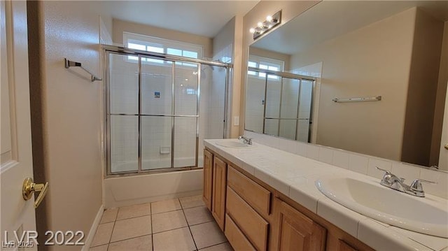 1211 Silver Knoll Ave, Las Vegas, NV 89123 - bathroom featuring tile patterned flooring, double vanity, enclosed tub / shower combo, and baseboards