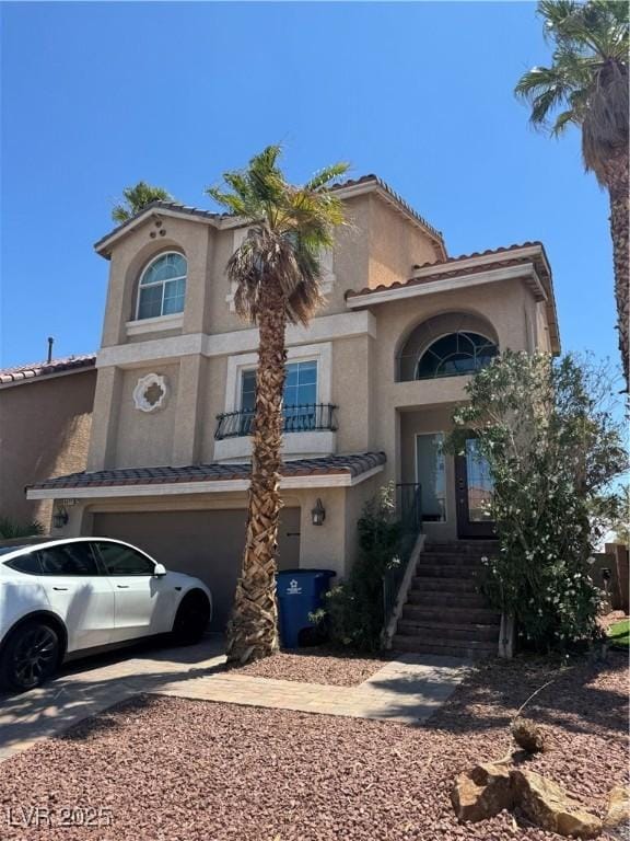 6877 Philharmonic Ave, Las Vegas, NV 89139 - mediterranean / spanish-style home with a garage, stucco siding, and a tile roof