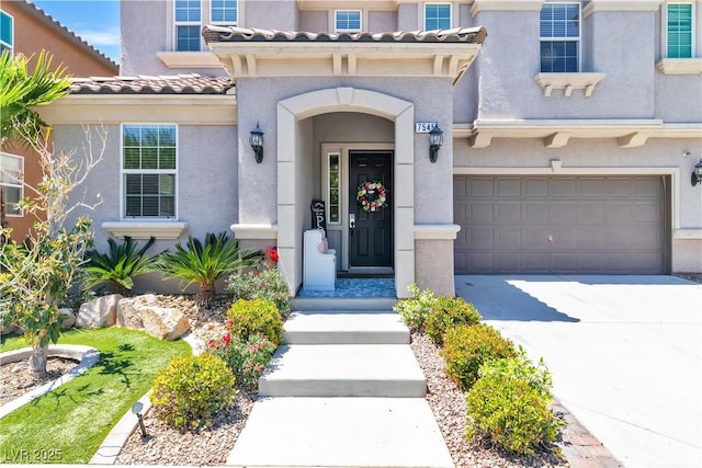 7545 Fontera Ct, Las Vegas, NV 89139 - property entrance with an attached garage, stucco siding, concrete driveway, and a tile roof