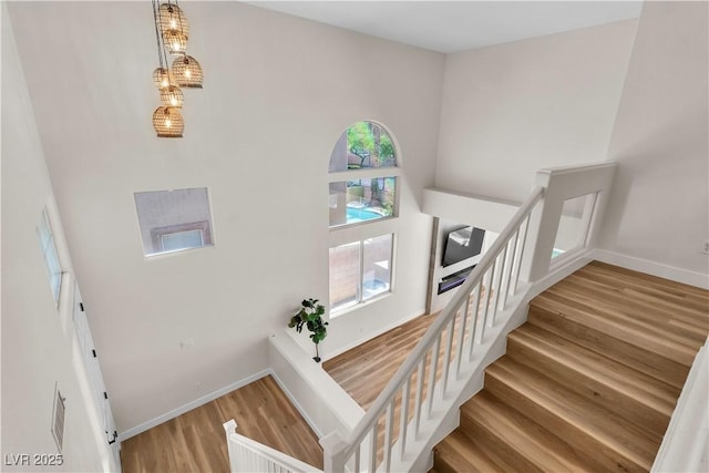 1551 Boundary Peak Way, Las Vegas, NV 89135 - stairs featuring wood finished floors, baseboards, and a high ceiling