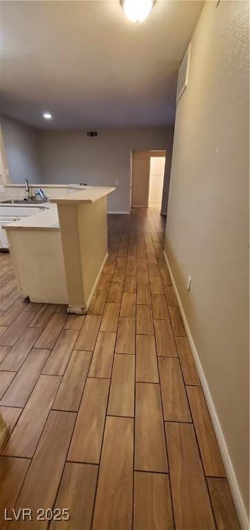 9000 Las Vegas Blvd Unit 1250, Las Vegas, NV 89123 - kitchen with wood finish floors, light countertops, a sink, and baseboards