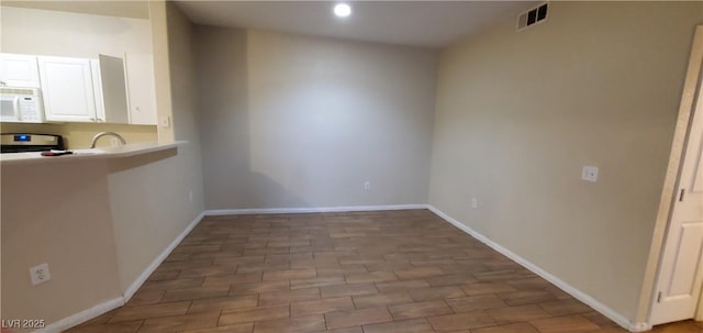 9000 Las Vegas Blvd Unit 1250, Las Vegas, NV 89123 - kitchen featuring white microwave, white cabinetry, baseboards, stainless steel electric range oven, and recessed lighting