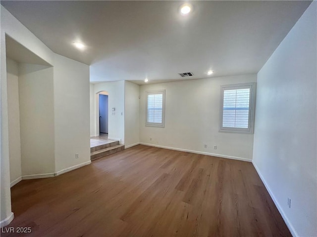 6545 Netherseal Ave, Las Vegas, NV 89139 - empty room with arched walkways, wood finished floors, baseboards, and recessed lighting