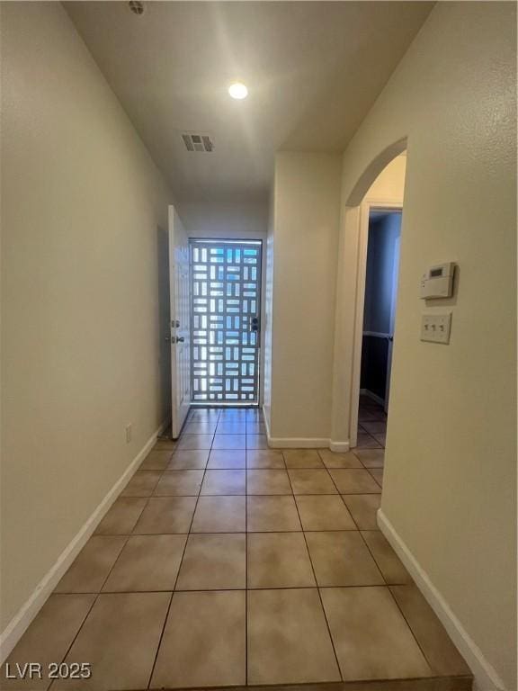 6545 Netherseal Ave, Las Vegas, NV 89139 - hallway featuring arched walkways, baseboards, light tile patterned flooring, and recessed lighting