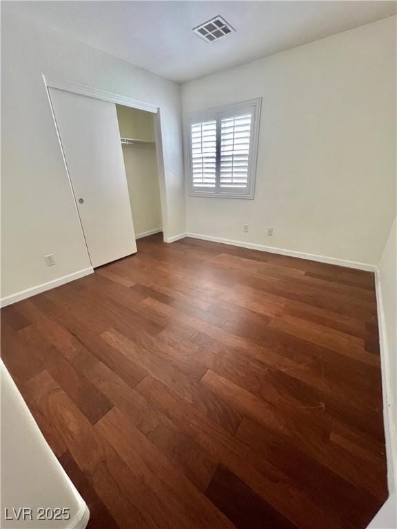 6545 Netherseal Ave, Las Vegas, NV 89139 - unfurnished bedroom with wood finished floors, baseboards, and a closet