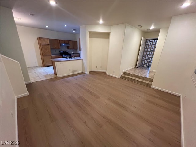 6545 Netherseal Ave, Las Vegas, NV 89139 - unfurnished living room with light wood finished floors and recessed lighting