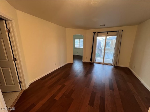 6545 Netherseal Ave, Las Vegas, NV 89139 - unfurnished room with arched walkways and dark wood-style flooring
