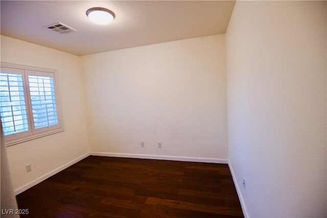 6545 Netherseal Ave, Las Vegas, NV 89139 - spare room featuring dark wood-style flooring and baseboards