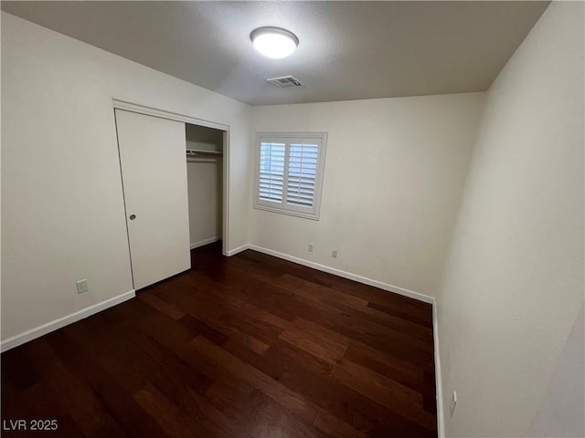 6545 Netherseal Ave, Las Vegas, NV 89139 - unfurnished bedroom with wood finished floors and a closet