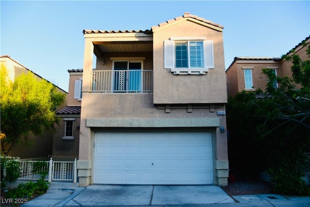 6545 Netherseal Ave, Las Vegas, NV 89139 - view of front facade with a balcony, stucco siding, a tiled roof, and concrete driveway