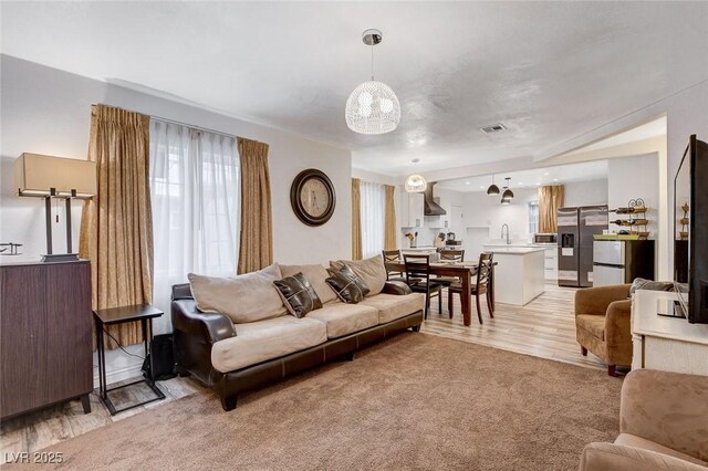 1414 S 13th St, Las Vegas, NV 89104 - living room featuring a chandelier and light carpet