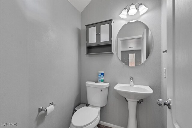 3964 Irvin Ave, Las Vegas, NV 89141 - half bathroom featuring toilet and vaulted ceiling