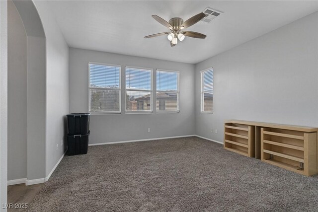 3964 Irvin Ave, Las Vegas, NV 89141 - carpeted empty room with a ceiling fan and arched walkways