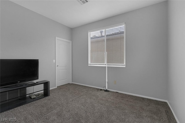 unfurnished living room featuring carpet floors and baseboards