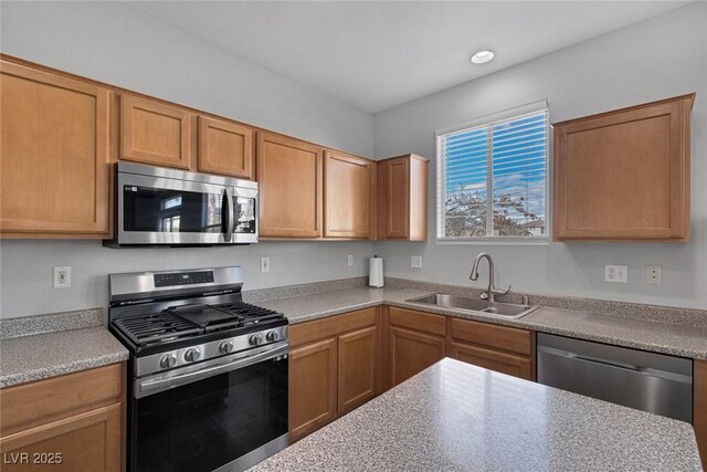 kitchen featuring stainless steel appliances, a sink, and light countertops