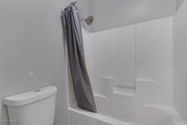 full bath featuring toilet, shower / bath combination with curtain, and a textured wall