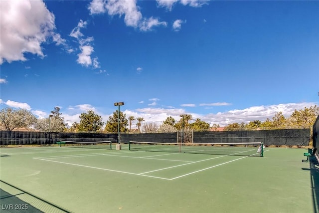 view of tennis court with fence and community basketball court