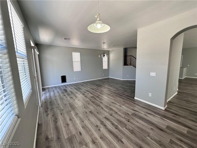 3964 Irvin Ave, Las Vegas, NV 89141 - spare room featuring arched walkways, dark wood-style floors, and plenty of natural light
