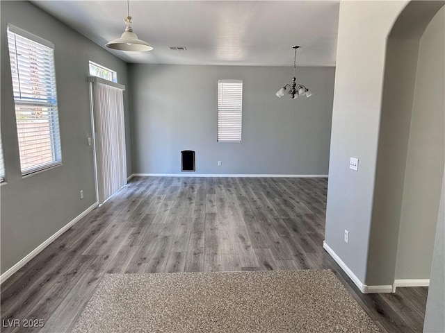 3964 Irvin Ave, Las Vegas, NV 89141 - empty room with wood finished floors, arched walkways, and a chandelier