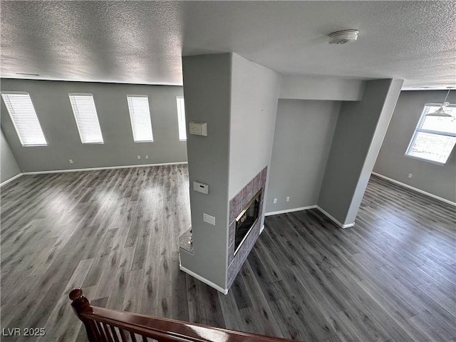 3964 Irvin Ave, Las Vegas, NV 89141 - empty room with a textured ceiling, wood finished floors, a smoke detector, and a tiled fireplace