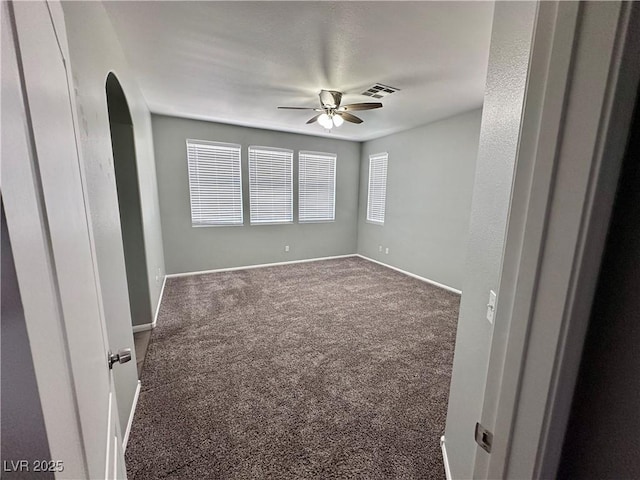 3964 Irvin Ave, Las Vegas, NV 89141 - carpeted empty room with a ceiling fan and arched walkways
